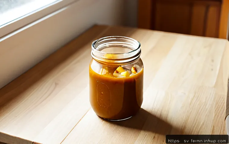 자가 발효로 만든 카레 소스 - Photorealistic close-up of homemade naturally fermented curry sauce in a clear glass jar on a light ...